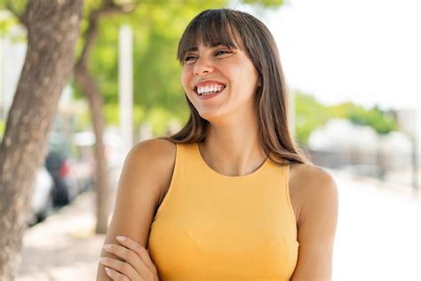 Premium Photo | Young woman at outdoors happy and smiling