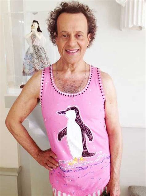 an old man wearing a pink tank top with a penguin on it