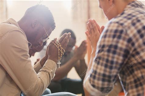 Men praying with rosary in prayer group - Stock Image - F023/9268 ...