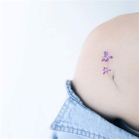 Iris flower tattoo on the left shoulder blade.