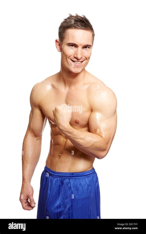 Muscular young man flexing arm muscles in sports outfit smiling on white background Stock Photo ...