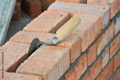 Clay brick arranged to form brick wall. Stock Photo | Adobe Stock