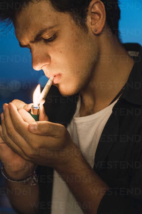 Young man smoking a joint stock photo