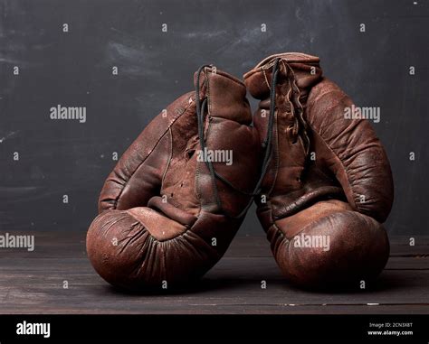 brown leather vintage boxing gloves on a black background Stock Photo - Alamy