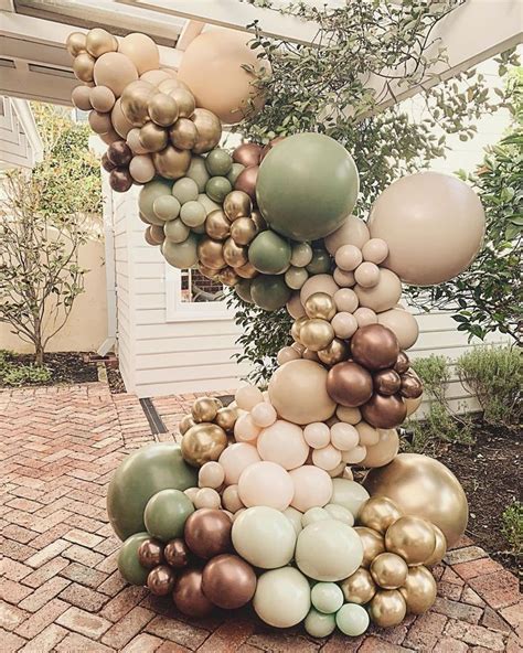 a bunch of balloons are stacked on top of each other in front of a house