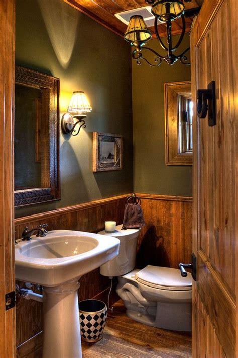 a bathroom with green walls and wood paneling