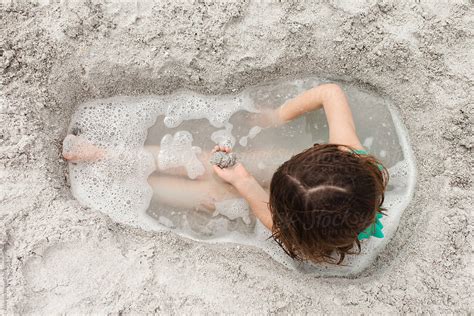 "Girl Covered In Sand At The Beach" by Stocksy Contributor "Amanda Worrall" - Stocksy