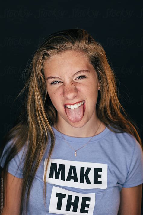 "Studio Portrait Of Cute Teen Girl Looking At Camera. She Is Sticking Out Tongue." by Stocksy ...