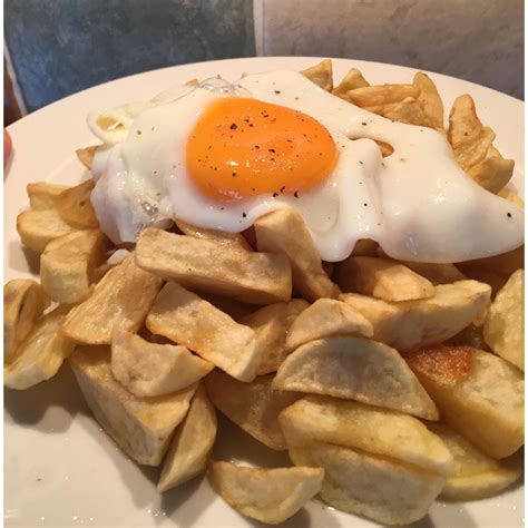 Homemade chippy style chips drenched in salt and vinegar and a fried ...