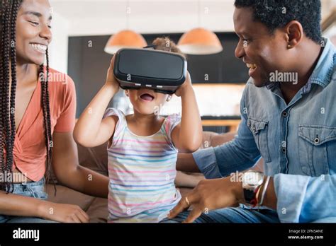 Family playing video games with VR glasses Stock Photo - Alamy
