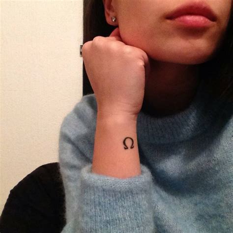 Wrist tattoo of the greek letter Omega on Kimberly.