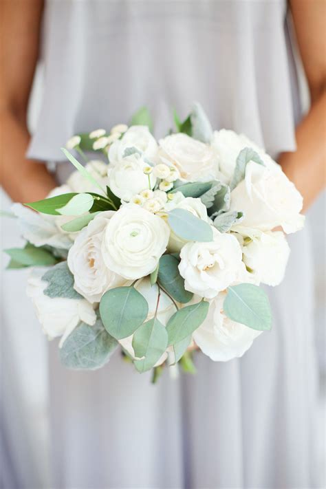 classic all white bridesmaids bouquet of white garden roses, white ranunculus, white spray ...