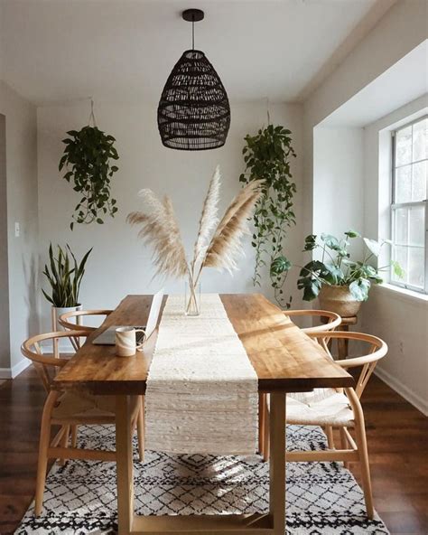 a dining room table and chairs with plants on the wall