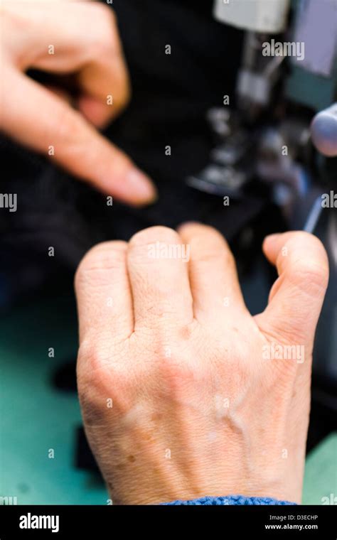 Hands work a sewing machine Stock Photo - Alamy