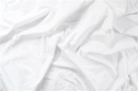 Premium Photo | Crumpled sheet. morning bed. white fabric texture.