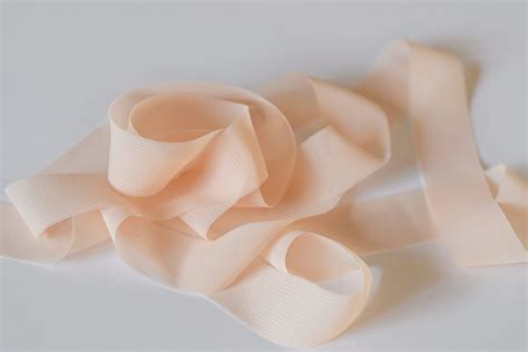 Chiffon ribbon with delicately frayed edges in pastel peach - Mayflower