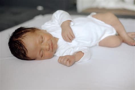 Premium Photo | Child sleeping newborn smiles in sleep