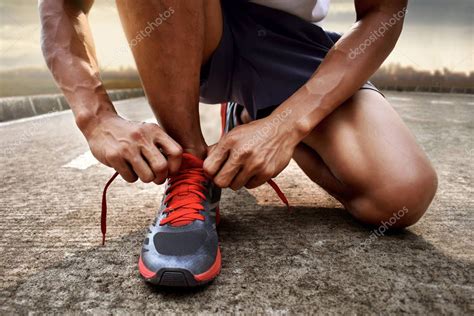 Man tying running shoes — Stock Photo © fotokitas #150379124