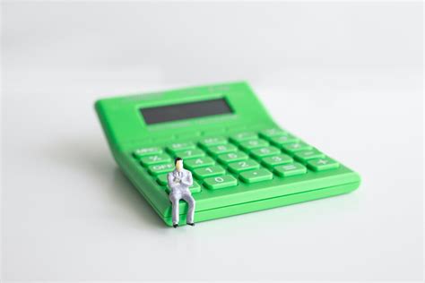 Green Calculator on White Table · Free Stock Photo