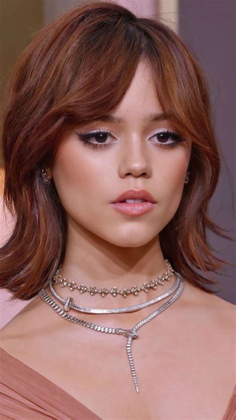 a close up of a woman wearing a necklace and choker with diamonds on it