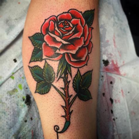 Long stem red rose tattoo on the calf.