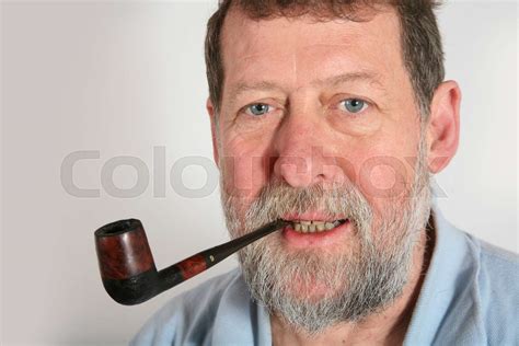 Mature scandinavian man smoking pipe | Stock image | Colourbox