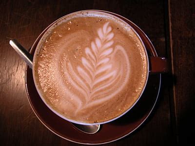 Royalty-Free photo: Bubbly coffee served on white ceramic coffee mug | PickPik
