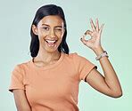 Portrait, perfect hand gesture and woman in a studio with a positive, confident and happy ...