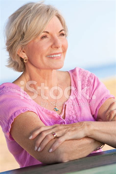 Happy Attractive Senior Woman Sitting Outside Stock Photo | Royalty-Free | FreeImages