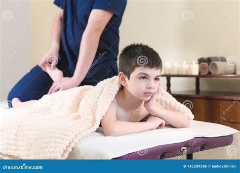 Little Boy Patient at Reception at a Professional Masseuse. Foot ...