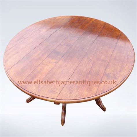 a round wooden table with four legs