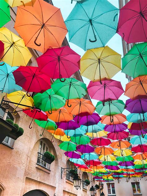 Photo of Assorted-Color Umbrellas Hanging Near Building · Free Stock Photo