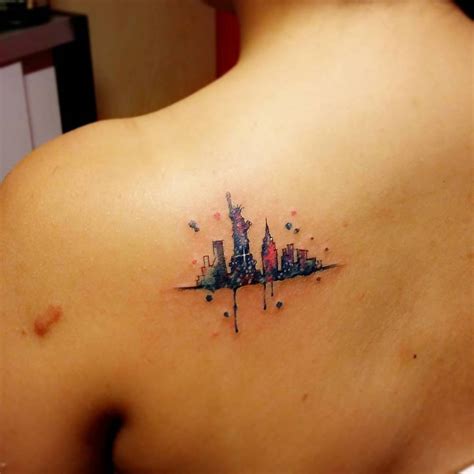 Watercolor style New York skyline tattoo on the left