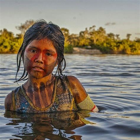 This beautiful Kayapó girl swims in the waters of the mighty Xingú River of the Brazilian Amazon ...