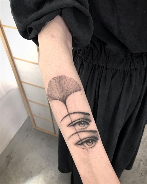 a woman's arm with an eye tattoo on it