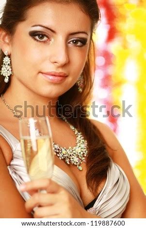 Beautiful young brunette woman drinking champagne at christmas party ...
