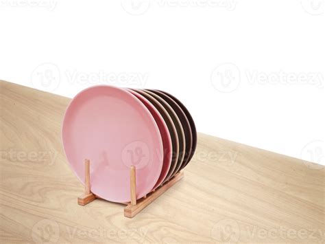 Ceramic plates in a wooden stand on a wooden table isolated PNG transparent 26798187 PNG