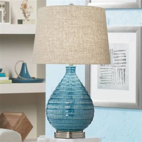 a blue lamp sitting on top of a table