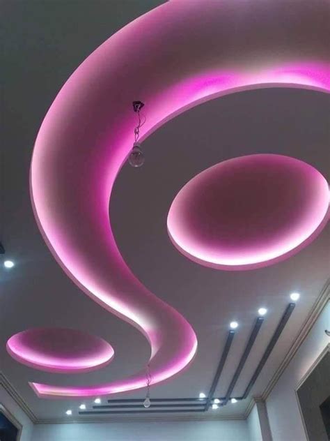 the ceiling is decorated with pink lights and circular circles on it's sides, along with ...