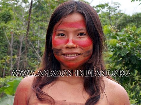 Matsés girl illustrating body painting with annatto (achiote). Despite ...