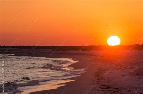 Orange Ocean beach sunset. Tropical Gulf Coast ocean beach sunset scene ...