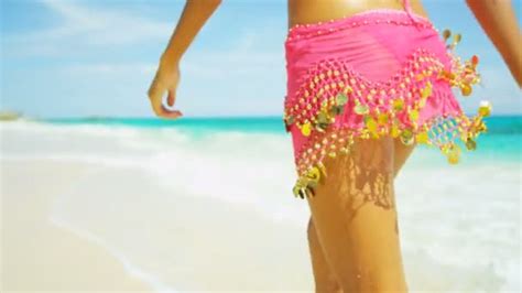 Tanned woman enjoying beach vacation — Stock Video © Spotmatik #101025612