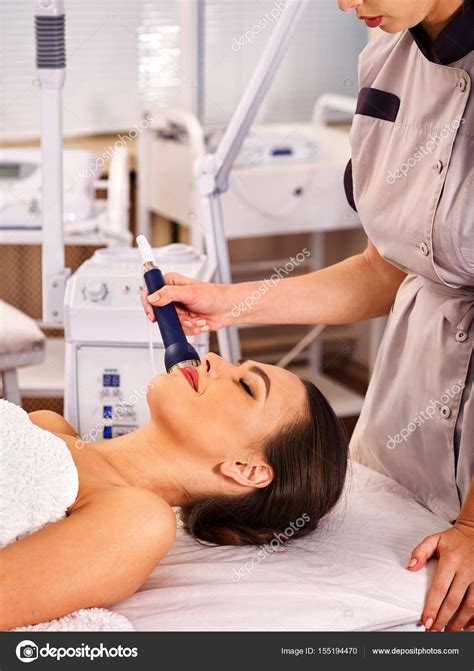 Ultrasonic facial treatment on ultrasound man face machine. Stock Photo by ©poznyakov 155194470