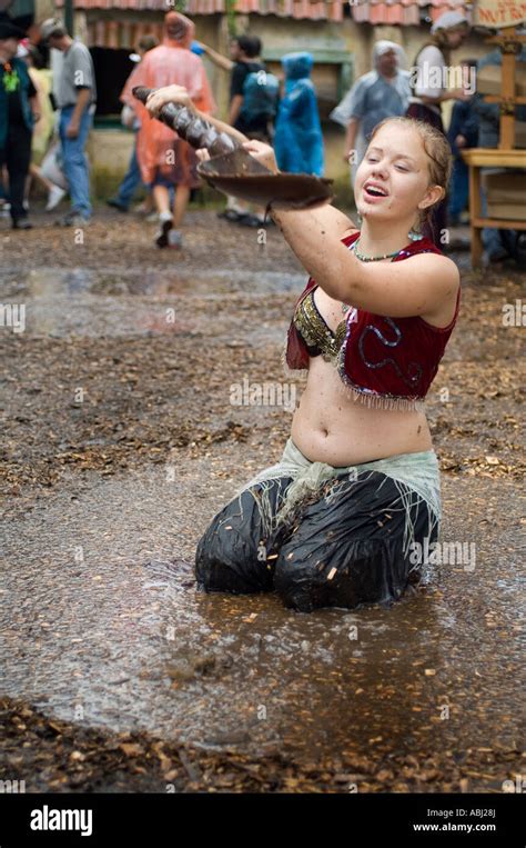 A girl playing in the mud at the Minnesota Renaissance Festival Stock ...