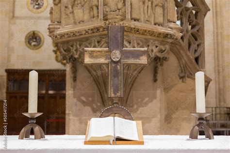 Open bible with a cross and two candles at an altar inside Ulm ...