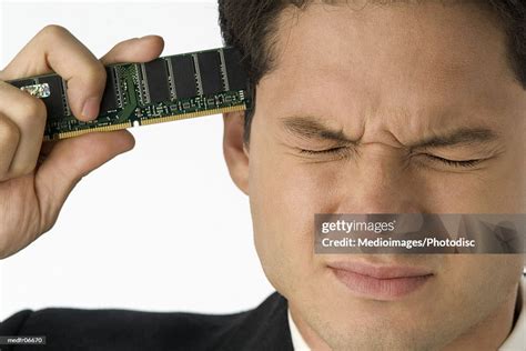 Businessman Holding Computer Ram Chip Pointed At His Head Closeup High-Res Stock Photo - Getty ...