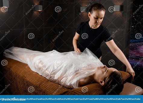 Woman Wrapped in a Polyethylene Wrap. Chocolate Spa Therapy Stock Photo ...