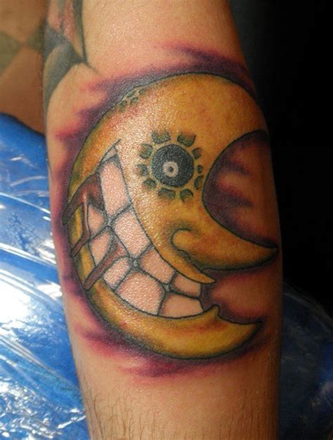 a man with a tattoo on his arm that has an image of the moon in it