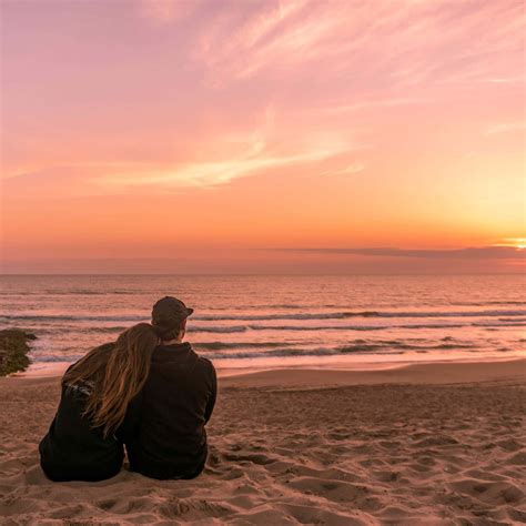 Download Couple At Beach Sitting On Sand During Sunset Picture ...