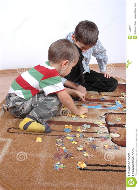 Boys playing the puzzle stock image. Image of enigma - 11588637